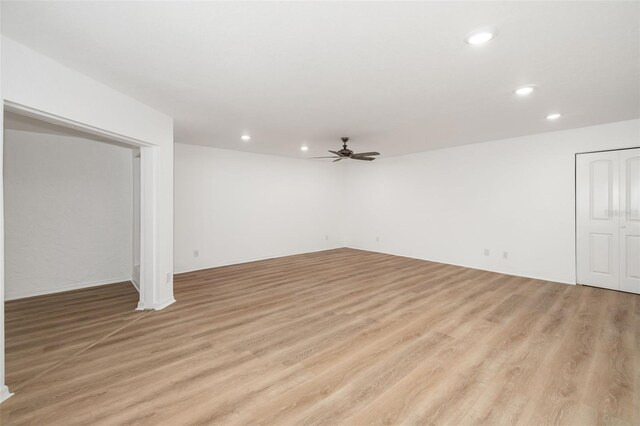 basement featuring ceiling fan and light wood-type flooring