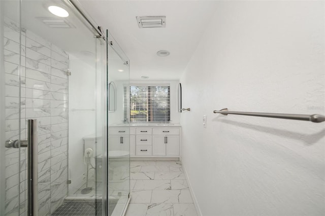 bathroom featuring vanity and a shower with shower door