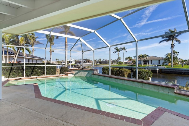 pool with a water view, glass enclosure, and a patio area