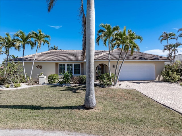 view of front of property with a garage and a front lawn