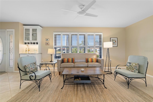 living room with ceiling fan and light tile patterned floors