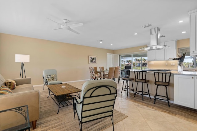 living room with ceiling fan and light tile patterned flooring