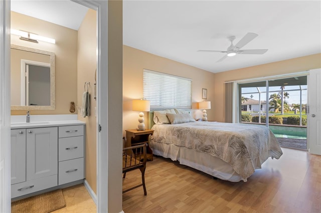 bedroom with access to outside, light wood-type flooring, a sink, and a ceiling fan