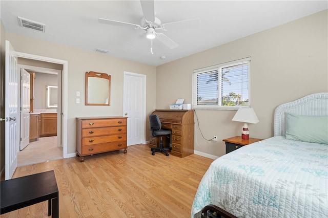 bedroom featuring ceiling fan, light wood finished floors, visible vents, and baseboards