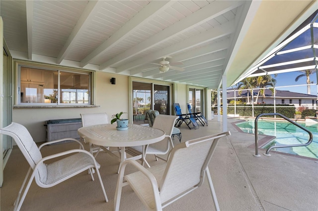 view of patio featuring ceiling fan, an indoor pool, and glass enclosure