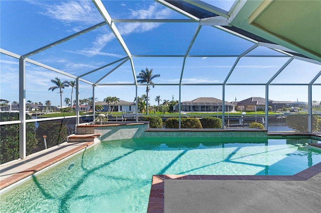 view of pool with a water view and glass enclosure