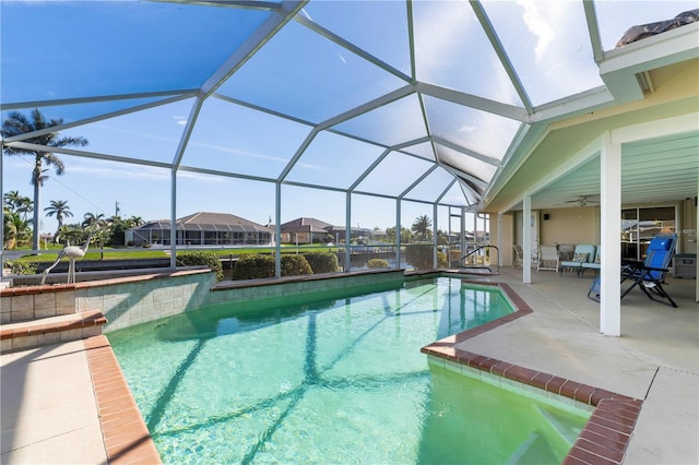 view of swimming pool with a lanai, a patio area, and ceiling fan