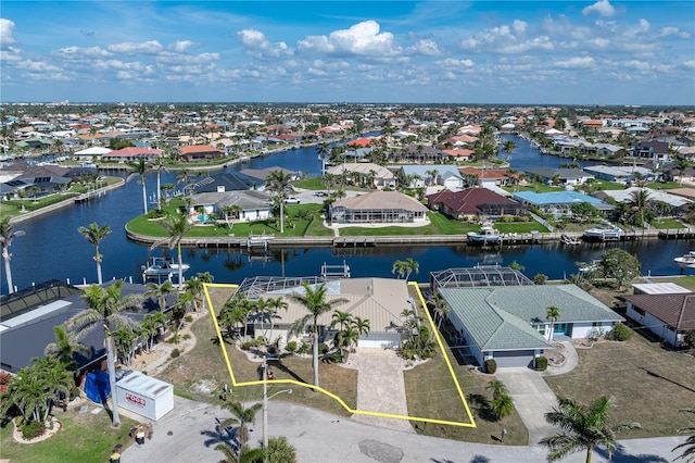 drone / aerial view with a water view and a residential view