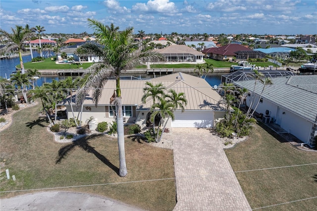 drone / aerial view featuring a water view and a residential view