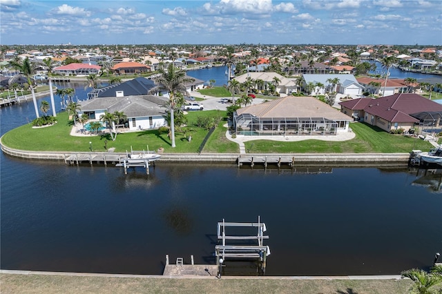 drone / aerial view with a water view and a residential view