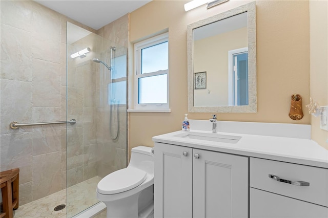 bathroom with toilet, a walk in shower, and vanity