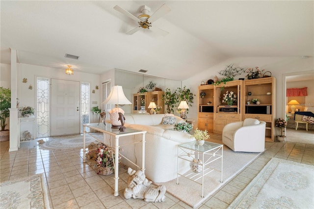 tiled living room featuring vaulted ceiling and ceiling fan