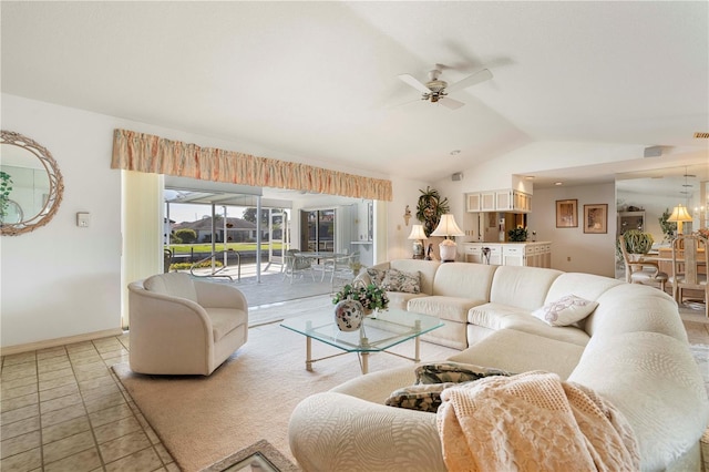 living room featuring vaulted ceiling, light tile patterned floors, and ceiling fan