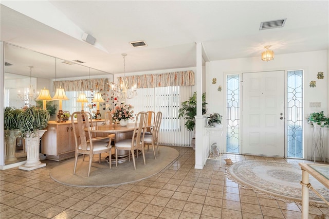 entryway featuring light tile patterned floors and a notable chandelier