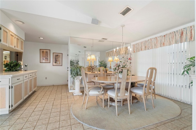 tiled dining area with a chandelier