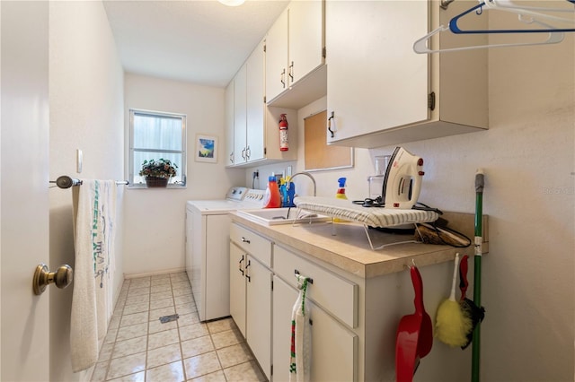 kitchen with white cabinetry, light tile patterned floors, sink, and washer and dryer