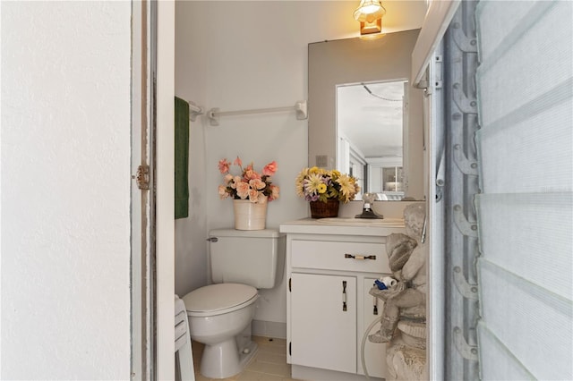 bathroom featuring vanity, tile patterned floors, and toilet