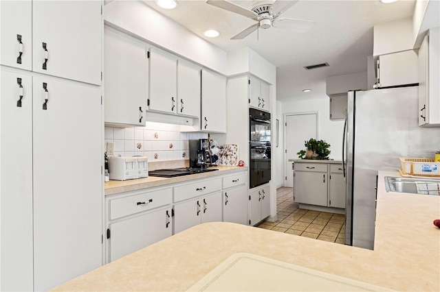 kitchen with white cabinets, decorative backsplash, light tile patterned floors, ceiling fan, and black appliances