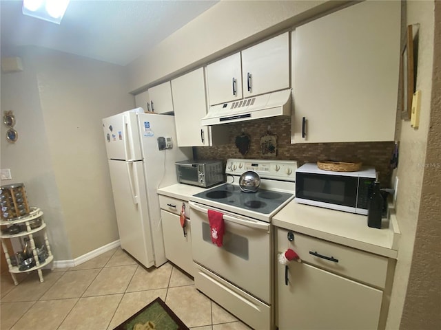 kitchen featuring backsplash, light tile patterned floors, white cabinets, and white appliances