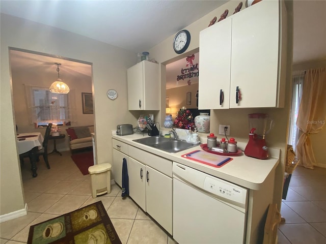 kitchen with sink, white cabinets, hanging light fixtures, light tile patterned floors, and white dishwasher