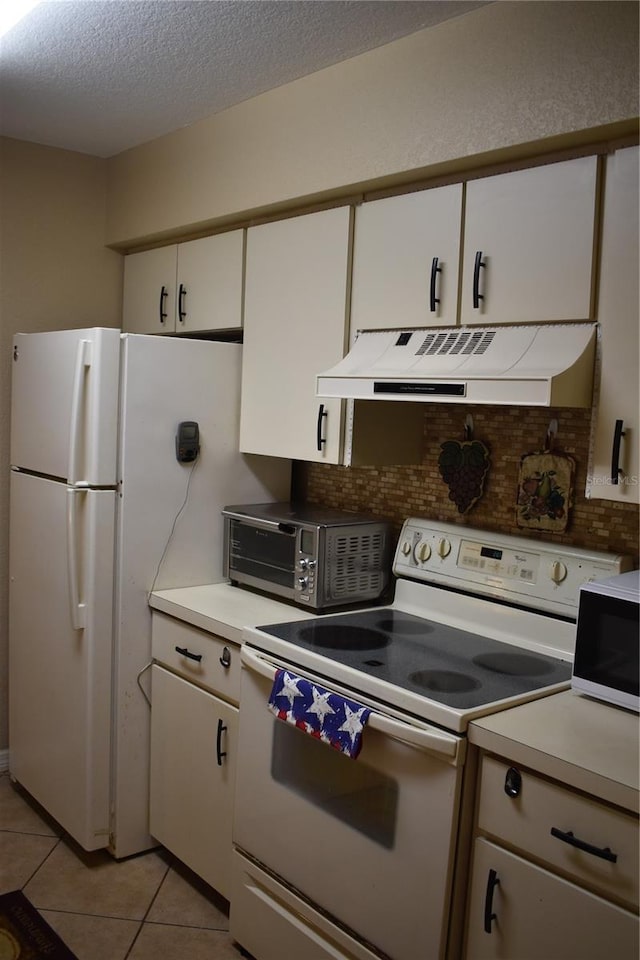 kitchen featuring light tile patterned floors, white appliances, white cabinetry, backsplash, and extractor fan