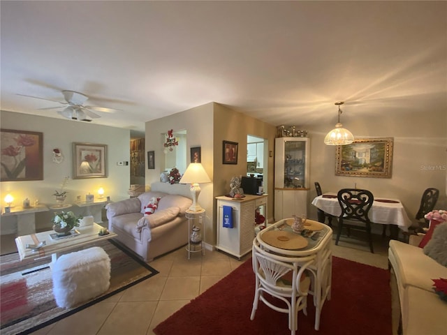 tiled living room with ceiling fan