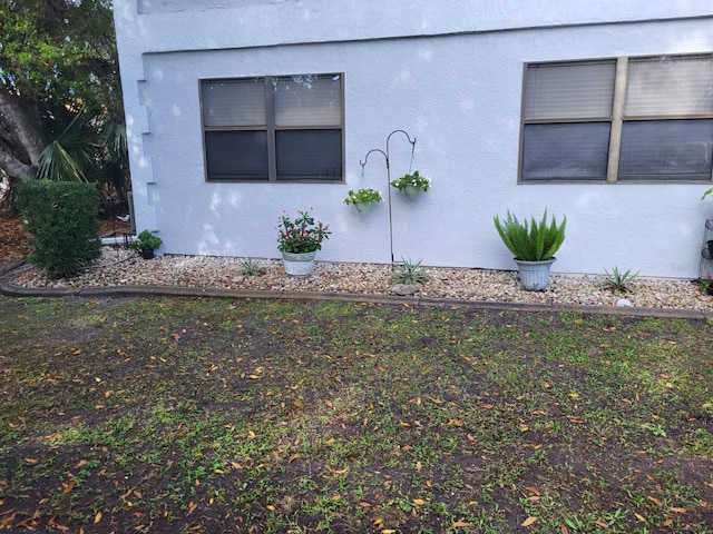 view of side of home with stucco siding