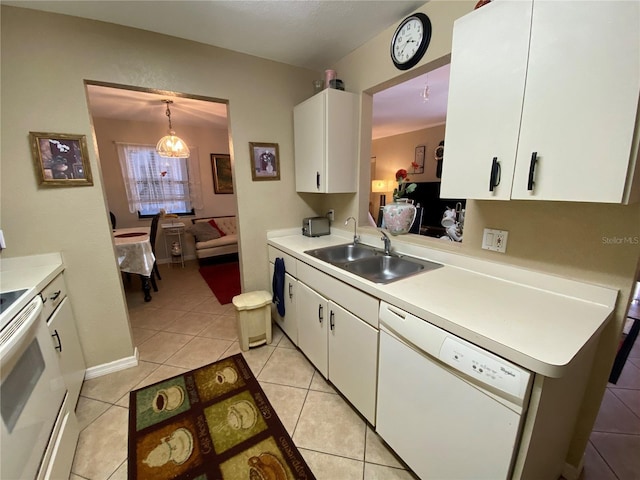 kitchen with white appliances, white cabinets, and light countertops