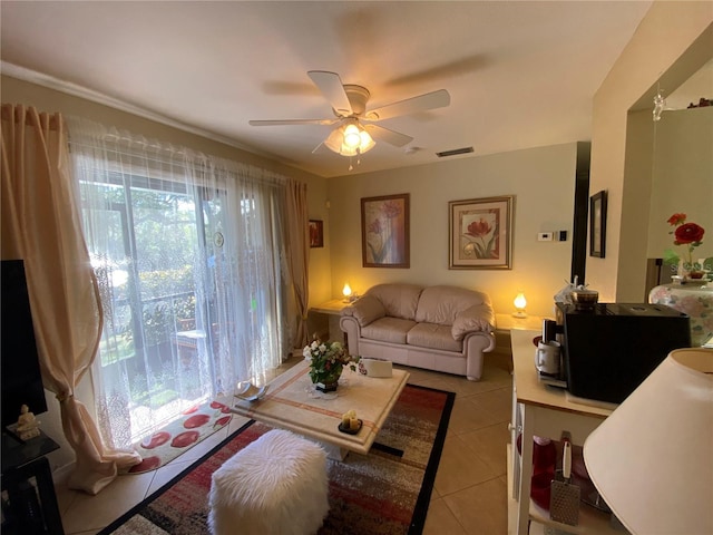 living room with light tile patterned floors, visible vents, and a ceiling fan