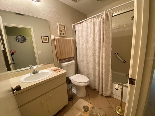 full bathroom featuring visible vents, toilet, shower / bath combo, vanity, and tile patterned floors