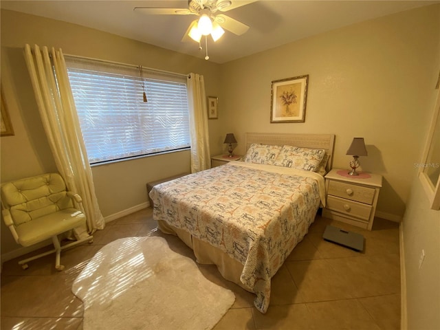 bedroom with light tile patterned floors, ceiling fan, and baseboards