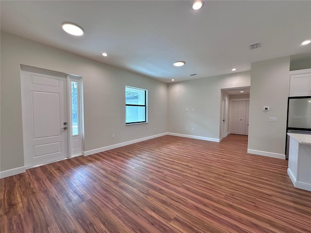 unfurnished living room featuring dark hardwood / wood-style flooring