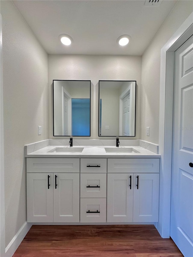 bathroom with wood-type flooring and vanity