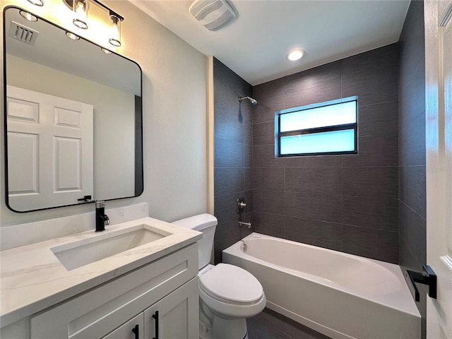 full bathroom featuring vanity, toilet, and tiled shower / bath