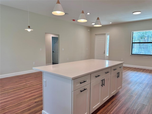 kitchen featuring white cabinetry, decorative light fixtures, and a kitchen island