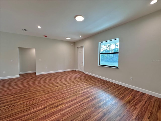 unfurnished room with wood-type flooring