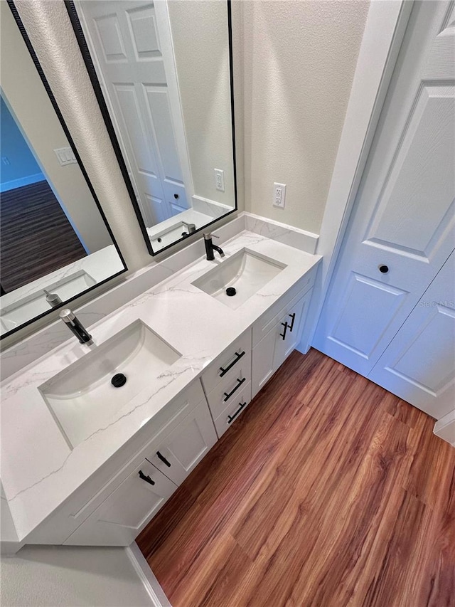 bathroom with vanity and hardwood / wood-style floors