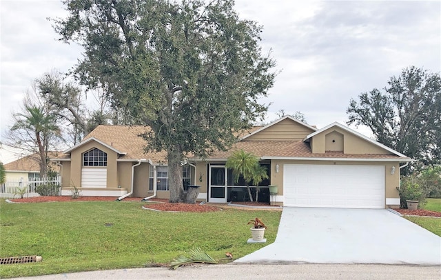 ranch-style house featuring a garage and a front lawn