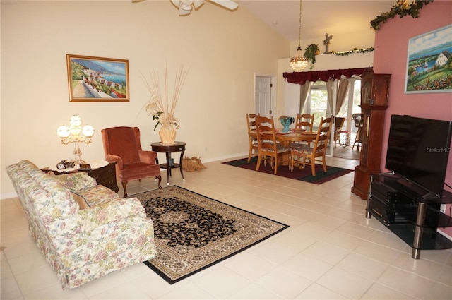 living room with ceiling fan, high vaulted ceiling, and light tile patterned floors