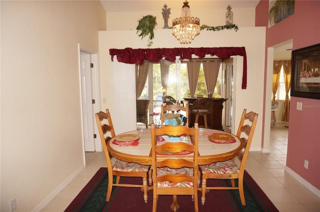 tiled dining room featuring a notable chandelier