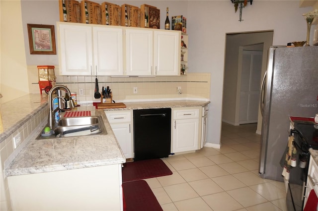 kitchen featuring light tile patterned flooring, sink, white cabinetry, black electric range, and backsplash