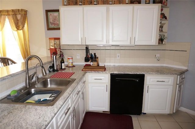 kitchen featuring white cabinetry, sink, and tasteful backsplash