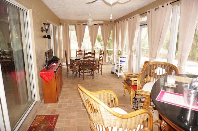 sunroom featuring ceiling fan