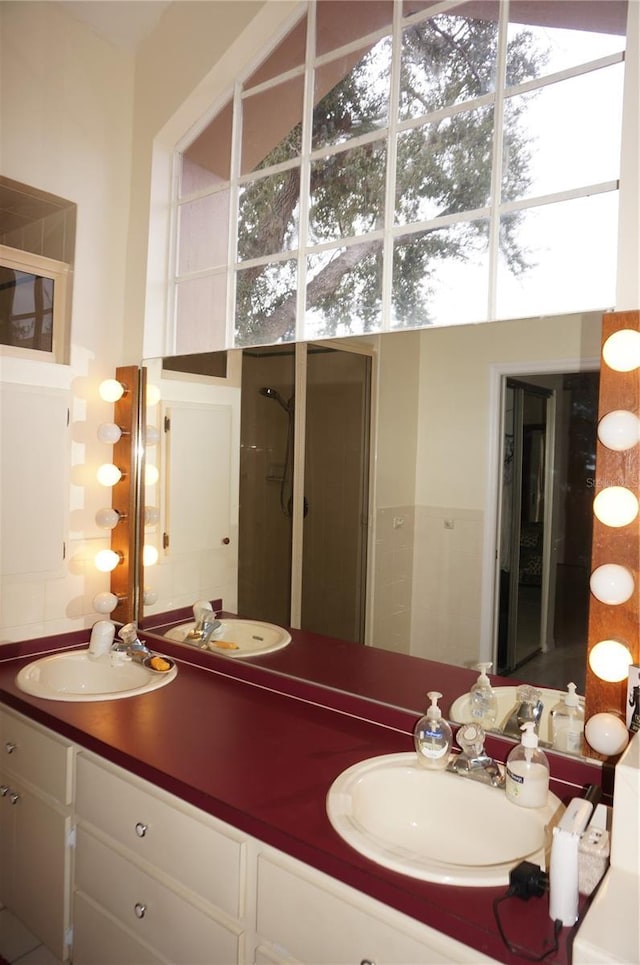 bathroom featuring walk in shower and vanity