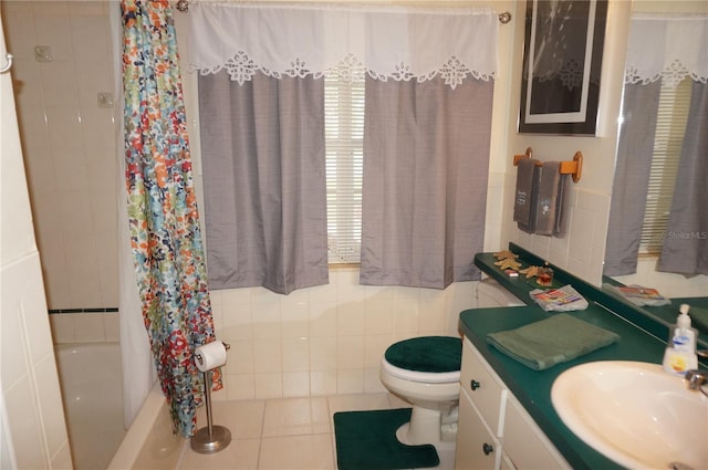 full bathroom featuring tile walls, vanity, toilet, shower / bath combo, and tile patterned floors