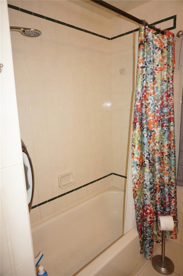 bathroom with shower / bath combination with curtain