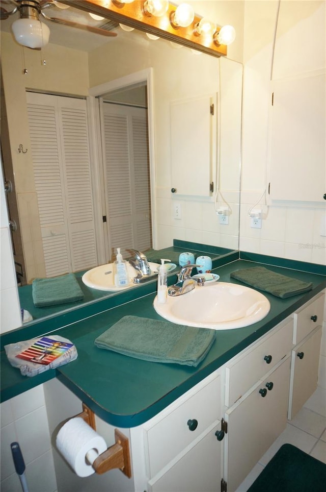 bathroom with tasteful backsplash, vanity, tile walls, and ceiling fan