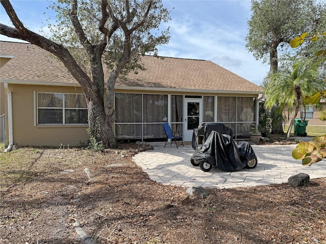 back of property featuring a patio area and a sunroom