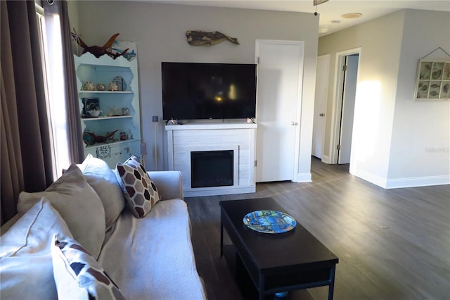 living room featuring plenty of natural light and dark hardwood / wood-style floors