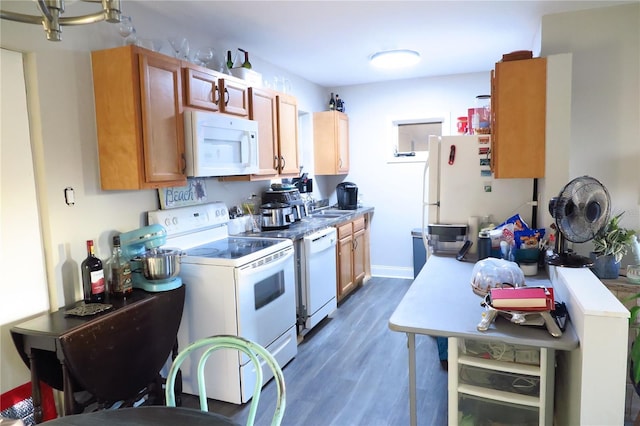 kitchen with dark hardwood / wood-style floors, sink, and white appliances